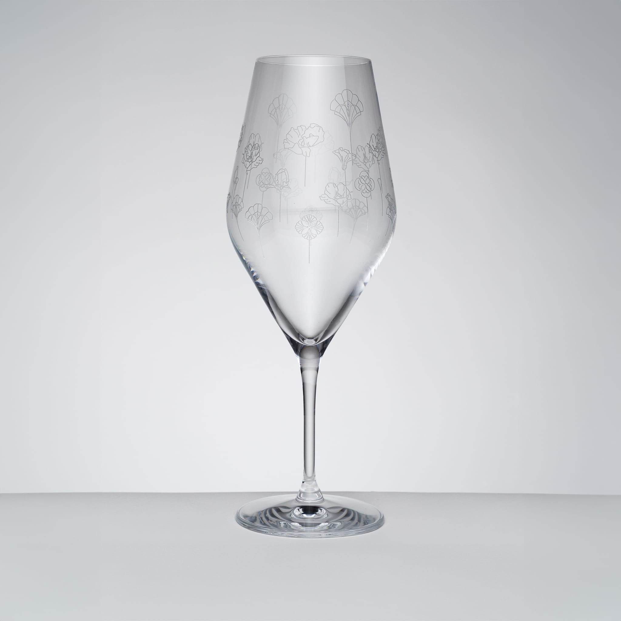 Klart champagneglass med tulipanform og subtilt blomstermønster, skandinavisk design fra Frederik Bagger
