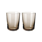 To brune, sylindriske vannglass i skandinavisk design fra Frederik Bagger, minimalistisk og funksjonelt.