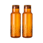 To brune glassflasker med rillet mønster, skandinavisk design fra Frederik Bagger – Norway.
