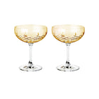 To fasettslipte, gule champagneskåler i krystallglass fra Frederik Bagger med diamantmønster