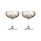 To fasettslipte champagneskåler i brun farget krystallglass fra Frederik Bagger, skandinavisk design.