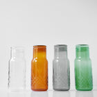 Fire fasettslipte karaffeler i klart, amber, røykfarget og grønt glass med skandinavisk design fra Frederik Bagger